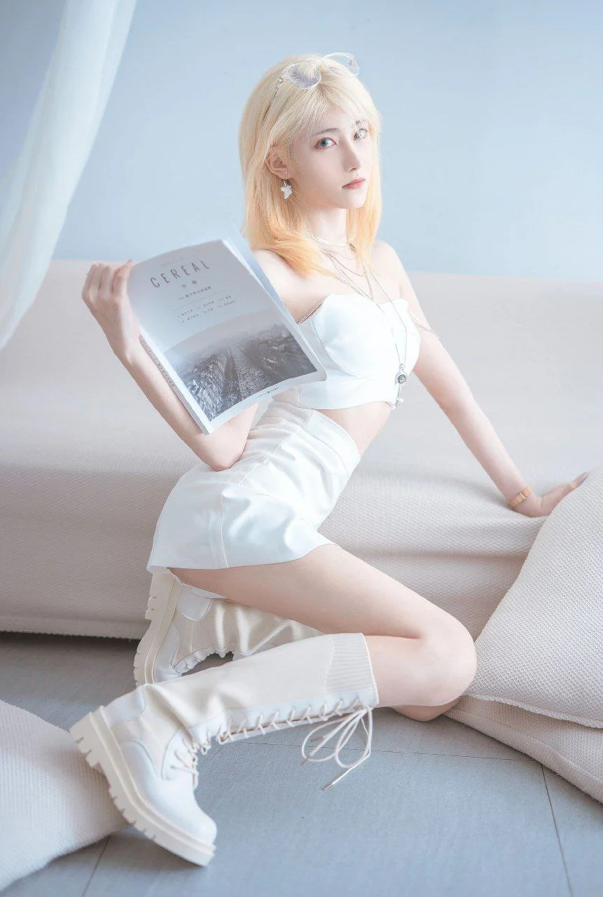 cosplay写真视觉图集与作品系列归档 白色服装造型人物坐在浅色空间中手持书本的照片