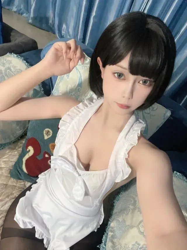 黑色短发造型下身穿白色荷叶边围裙连体服的俯拍半身展示